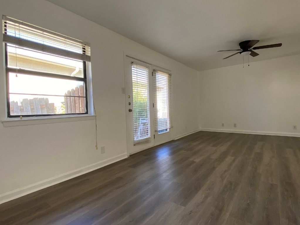 5813 Signal Point Austin, TX 78724 - Photo 4 of 12 a view of an empty room with wooden floor and a window