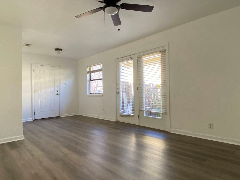 5813 Signal Point Austin, TX 78724 - Photo 6 of 12 a view of an empty room with a window and wooden floor