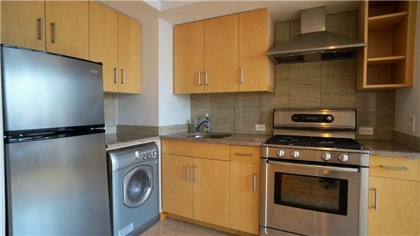 a kitchen with stainless steel appliances white cabinets and a stove top oven