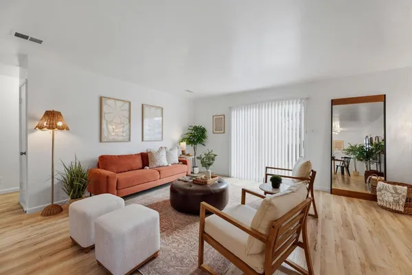 a living room with furniture and wooden floor