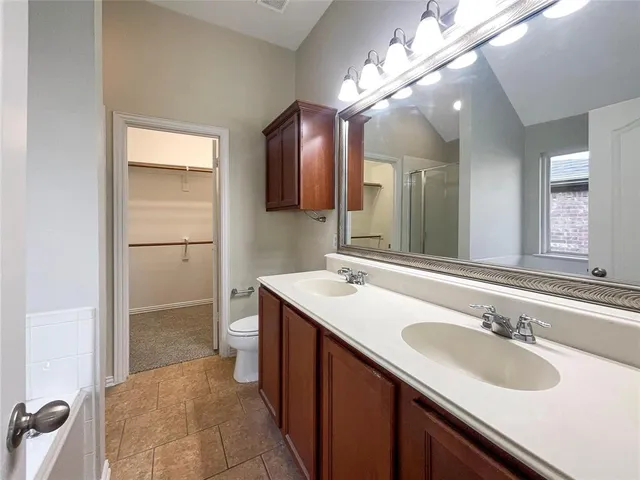 a bathroom with a sink vanity granite and a mirror
