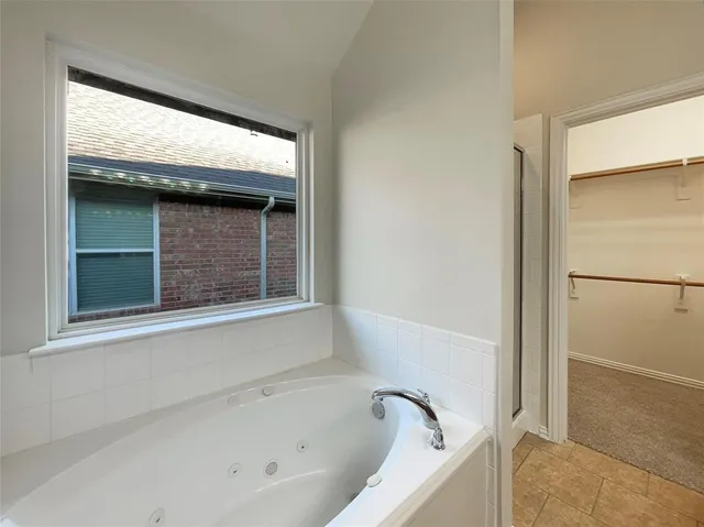 a white bath tub sitting next to a window