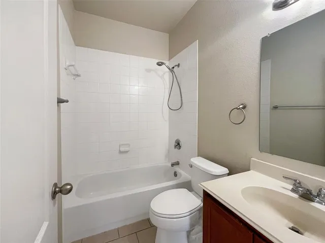 a bathroom with a sink toilet tub and shower