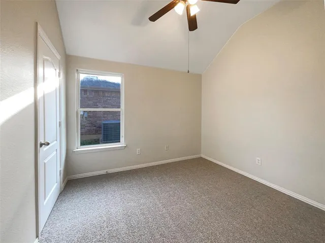 an empty room with a empty space and a ceiling fan