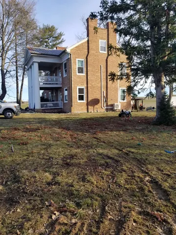 a big yard with large trees