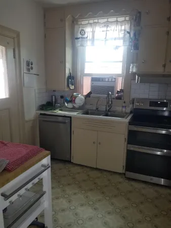 a kitchen with stainless steel appliances granite countertop a sink stove and cabinets