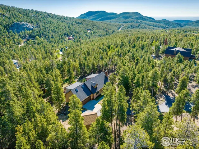 a view of a house with a yard and mountain