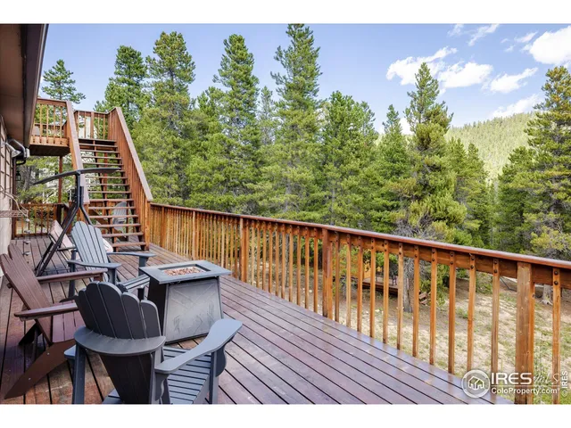 a balcony with wooden floor table and chairs