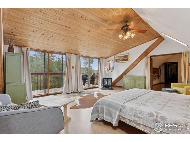 a bed room with a bed and a large window