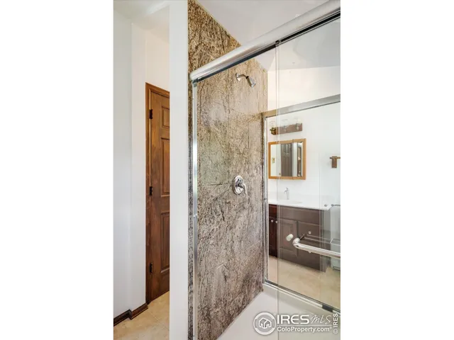 a bathroom with a shower and a sink