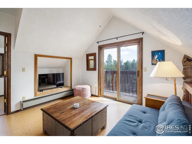 a living room with furniture a large window and a flat screen tv
