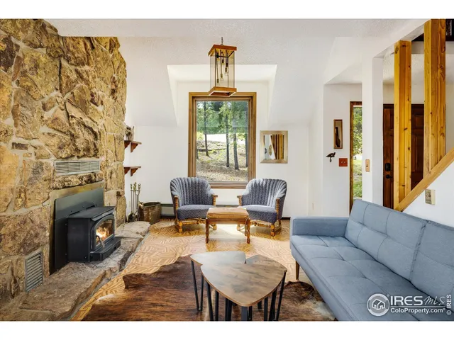 a living room with furniture a fireplace and a chandelier