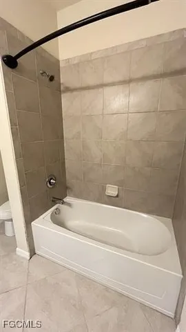 a bathroom with a tub and a shower