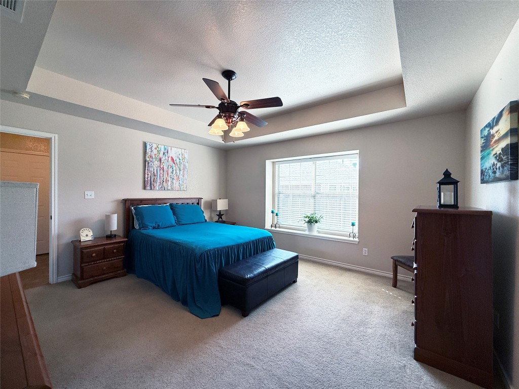 1502 Hamilton Street Burnet, TX 78611 - Photo 14 of 26 a bedroom with a bed window and dresser