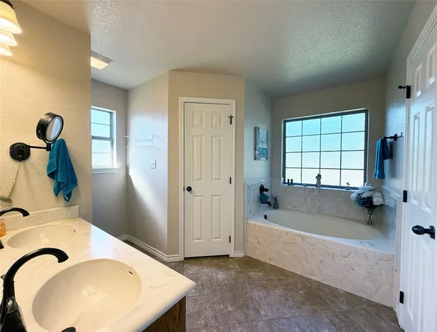 a bathroom with a bathtub and a window