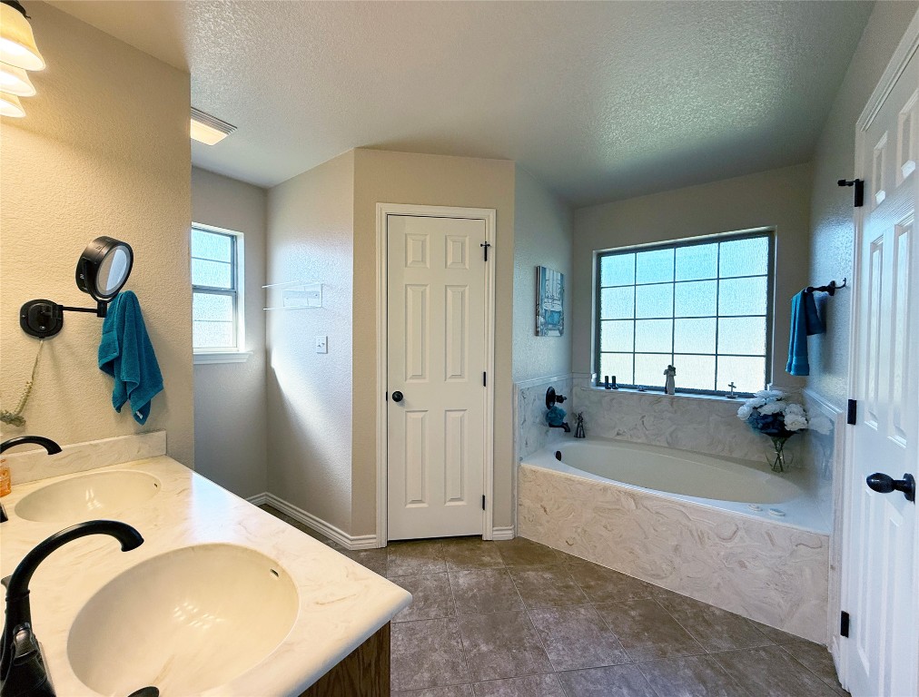 1502 Hamilton Street Burnet, TX 78611 - Photo 15 of 26 a bathroom with a bathtub and a window