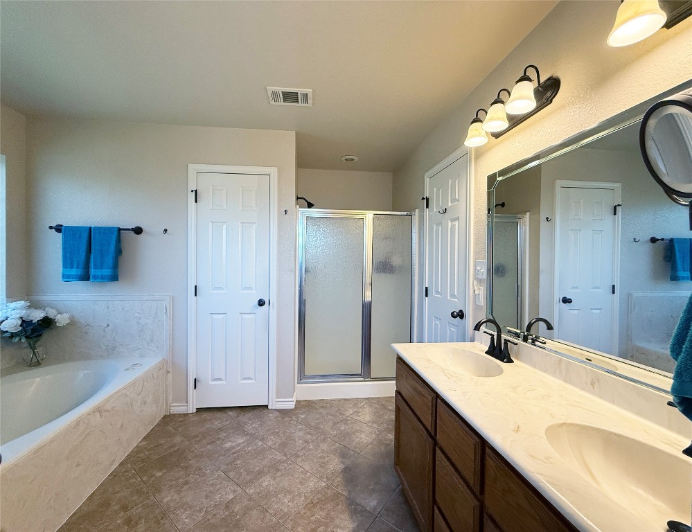 1502 Hamilton Street Burnet, TX 78611 - Photo 16 of 26 a bathroom with a granite countertop sink mirror and a bathtub