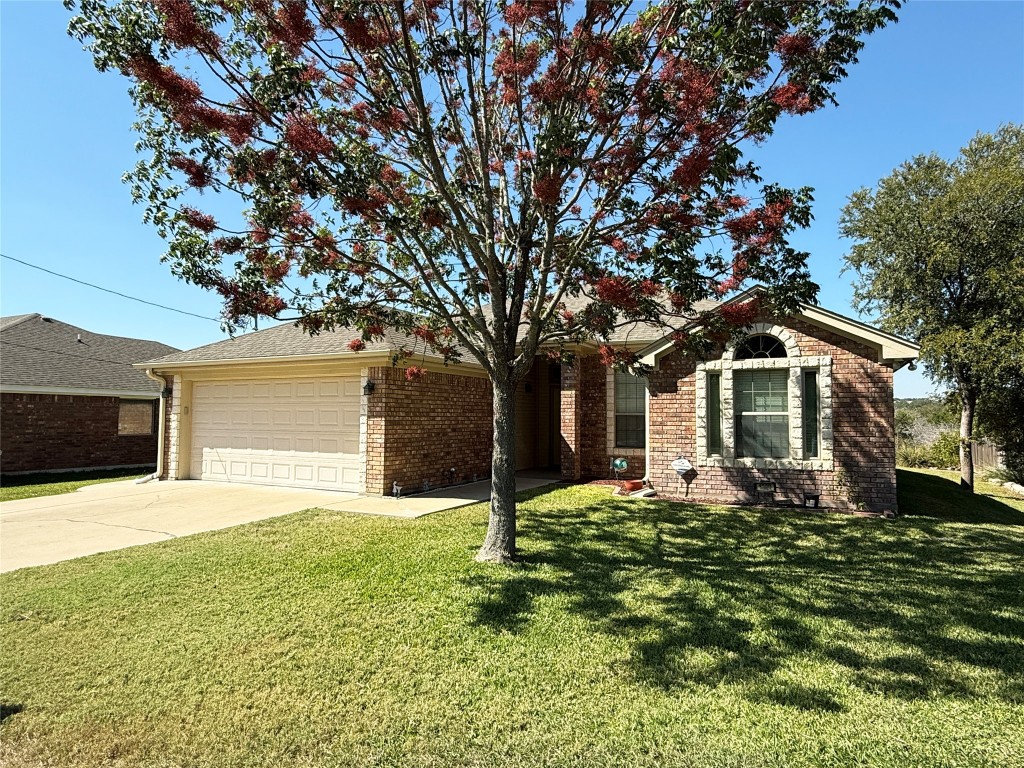 1502 Hamilton Street Burnet, TX 78611 - Photo 2 of 26 a front view of a house with a yard and trees