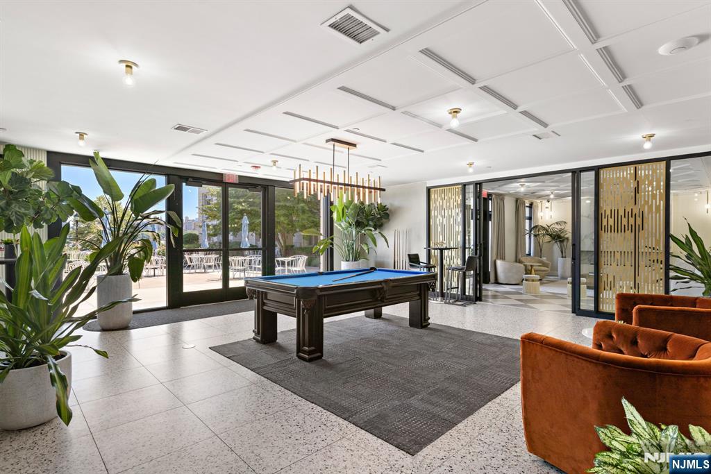 7400 River Road, Unit 208 North Bergen, NJ 07047 - Photo 17 of 18 a living room with furniture a rug potted plant and a large window
