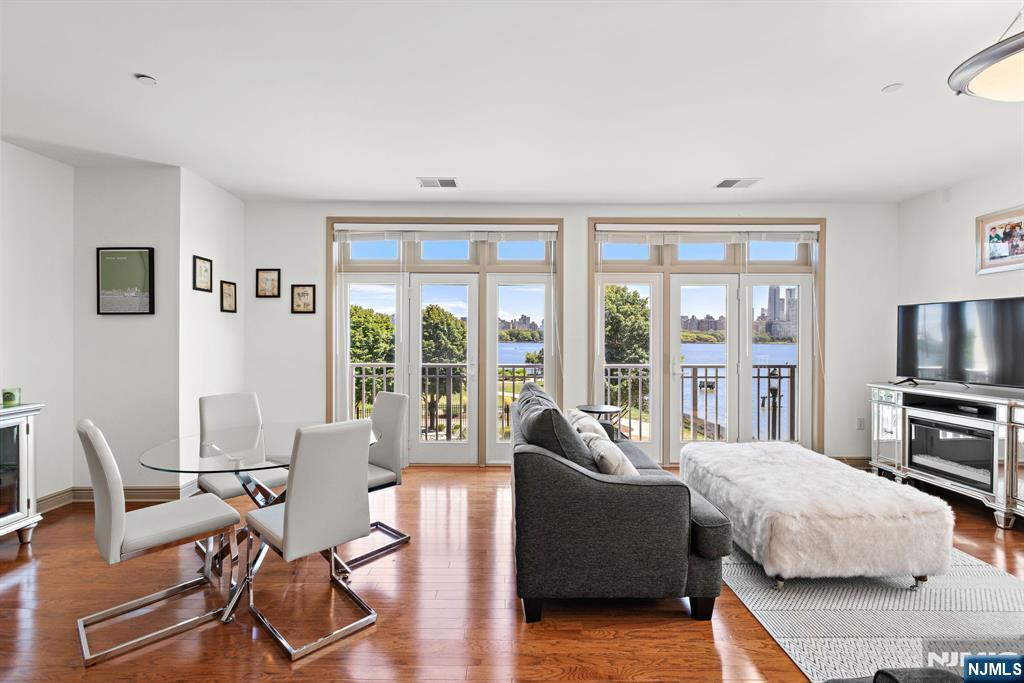 7400 River Road, Unit 208 North Bergen, NJ 07047 - Photo 3 of 18 a living room with furniture and a flat screen tv