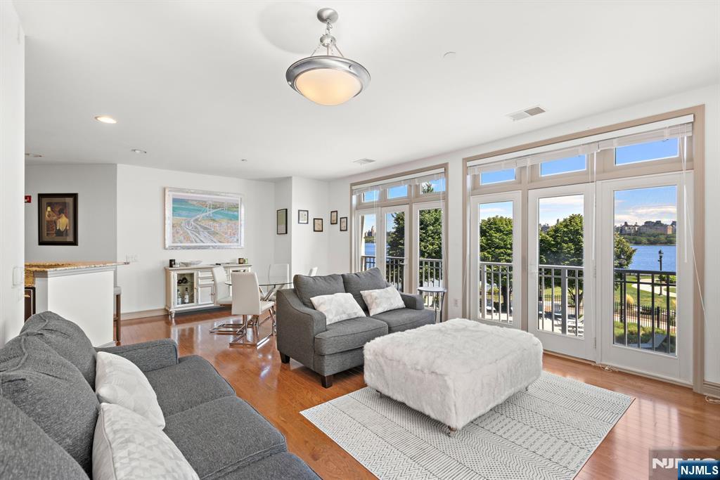 7400 River Road, Unit 208 North Bergen, NJ 07047 - Photo 7 of 18 a living room with furniture and a large window