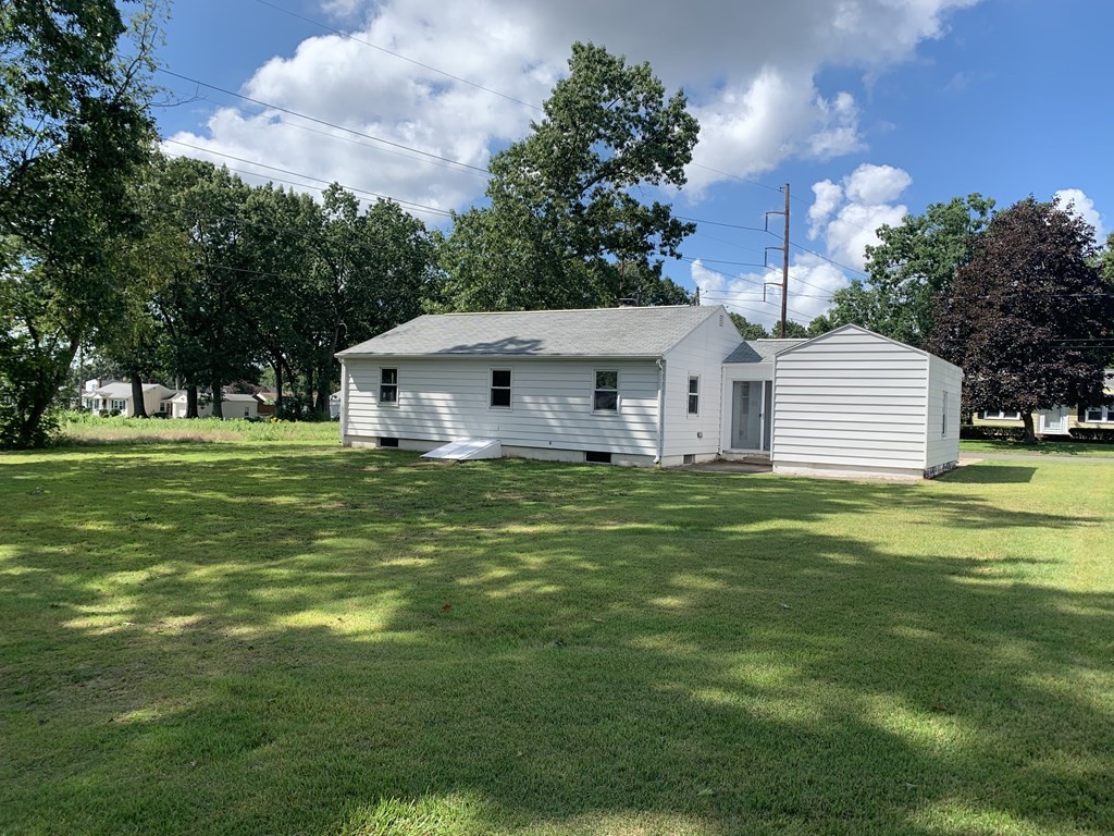 47 Bourbeau Street Chicopee, MA 01020 - Photo 19 of 19 a white house with a white ground and garden