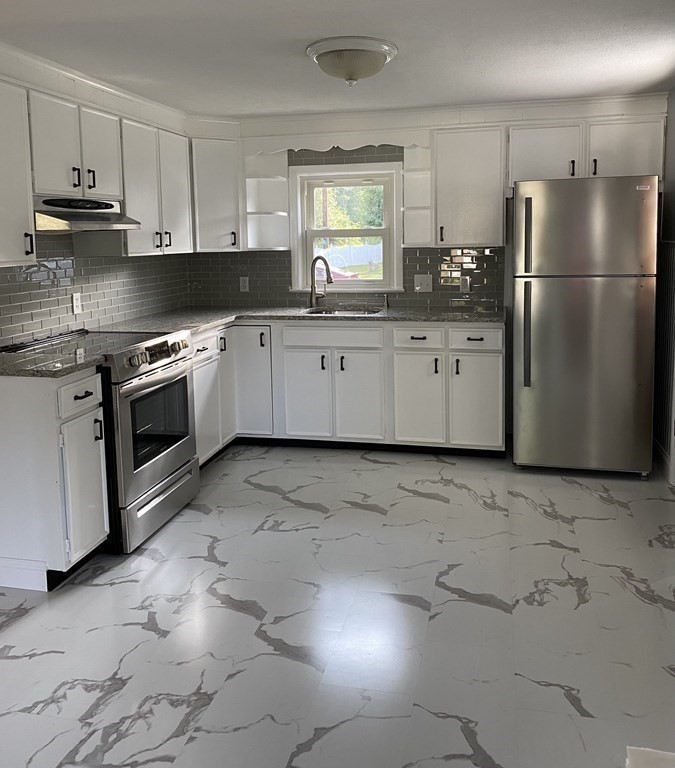 47 Bourbeau Street Chicopee, MA 01020 - Photo 6 of 19 a kitchen with granite countertop a refrigerator sink and cabinets