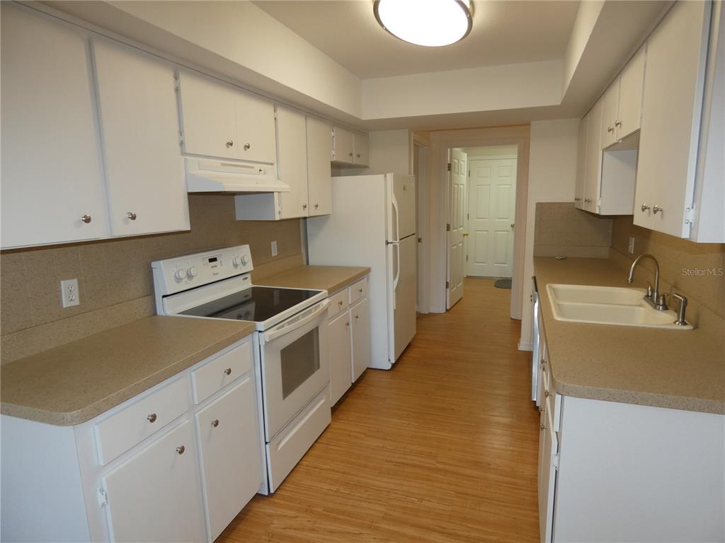 19181 Southwest 90th Ln Road Dunnellon, FL 34432 - Photo 6 of 37 a kitchen with granite countertop a sink a stove and refrigerator