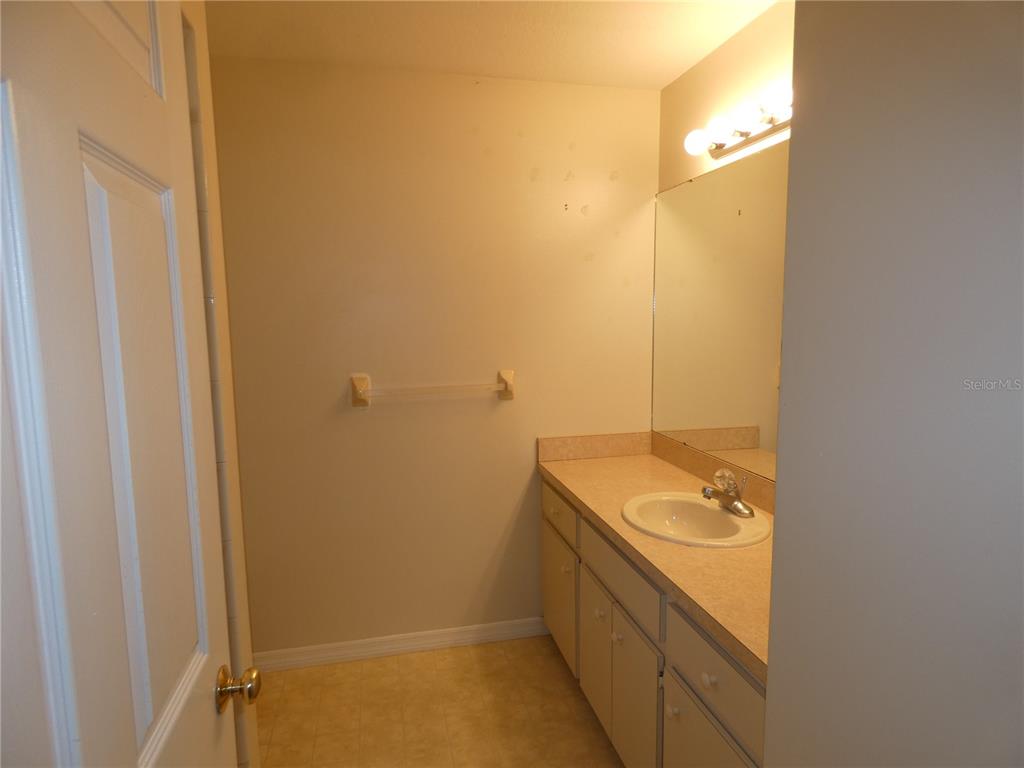 19181 Southwest 90th Ln Road Dunnellon, FL 34432 - Photo 9 of 37 a bathroom with a granite countertop sink and a mirror