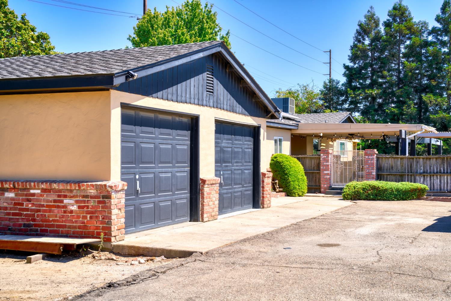 231 South Austin Road Manteca, CA 95336 - Photo 29 of 39 2 car garage with additional storage to the right of it.