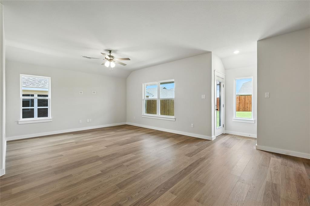 604 Martell Road Princeton, TX 75407 - Photo 13 of 38 a view of an empty room with window and wooden floor