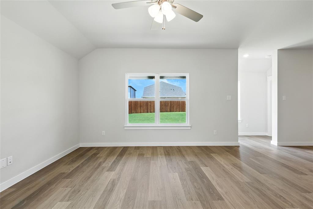 604 Martell Road Princeton, TX 75407 - Photo 14 of 38 an empty room with wooden floor and windows