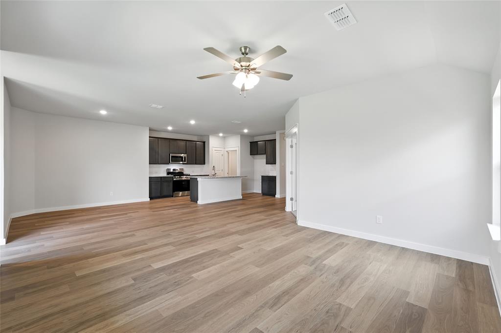 604 Martell Road Princeton, TX 75407 - Photo 16 of 38 a view of kitchen with cabinets and wooden floor