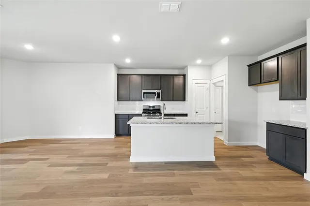 a kitchen with a sink stainless steel appliances and cabinets