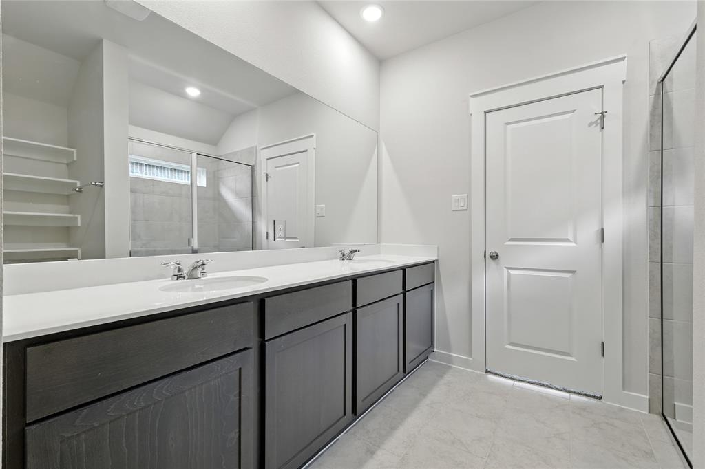604 Martell Road Princeton, TX 75407 - Photo 21 of 38 a bathroom with double sink and a mirror
