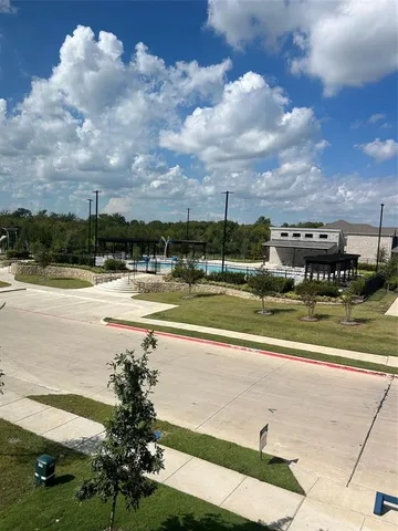a view of a swimming pool with outdoor seating