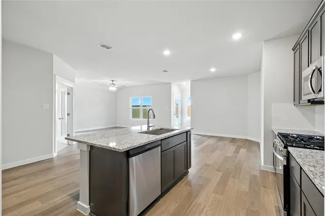 a kitchen with a sink stove and cabinets