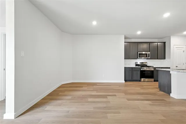 a view of kitchen with microwave and cabinets