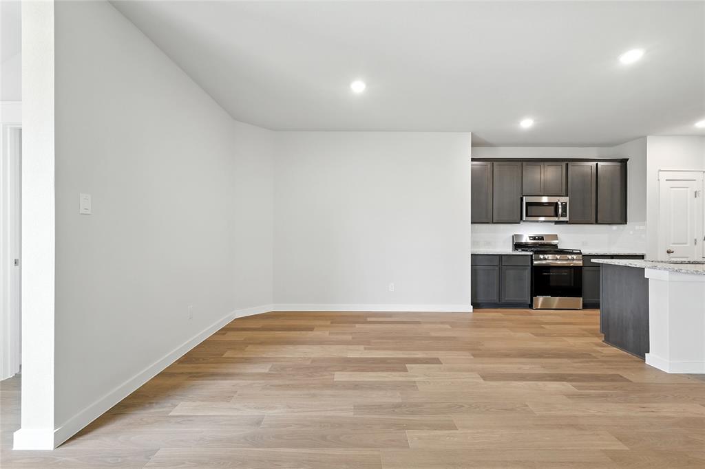 604 Martell Road Princeton, TX 75407 - Photo 10 of 38 a view of kitchen with microwave and cabinets