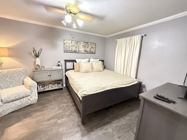 a bedroom with a bed and a chandelier