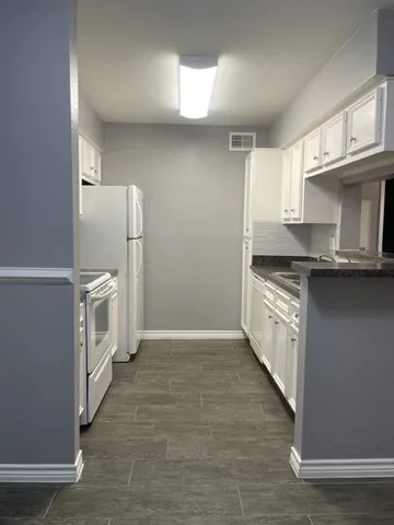 a kitchen with a sink a microwave a stove and refrigerator