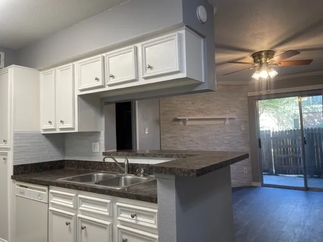 a kitchen with granite countertop a sink and a stove