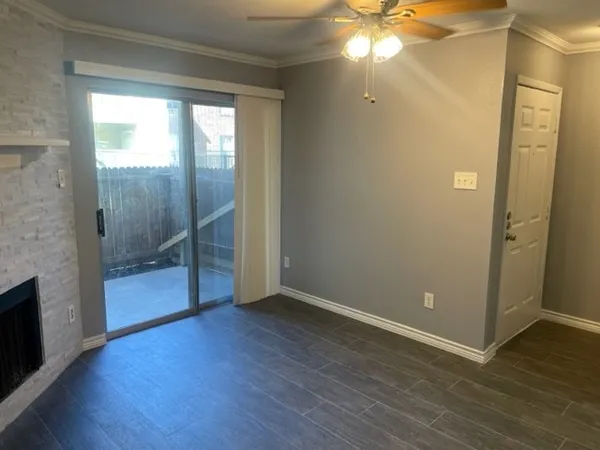 wooden floor in an empty room with a bathroom