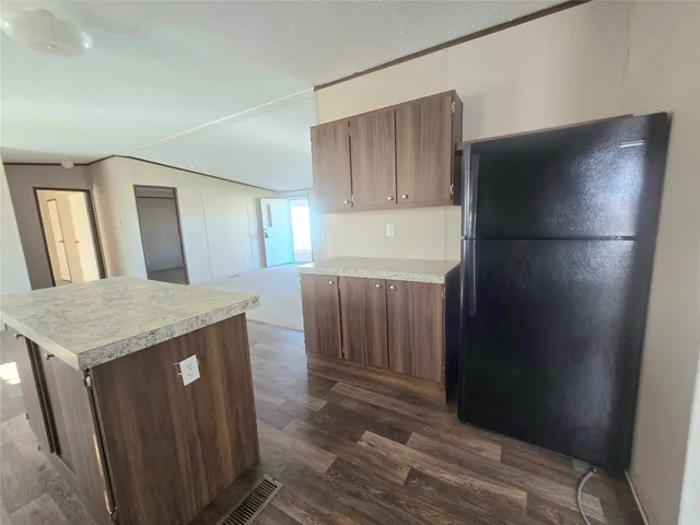 a kitchen with a refrigerator and a sink