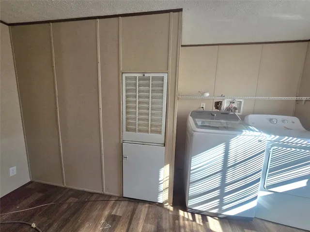 a bedroom with a bed and a window with wooden floor