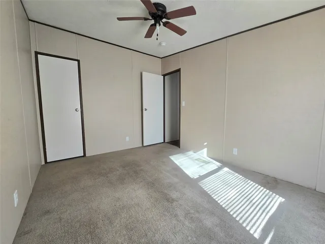 a view of a hallway with a chandelier fan