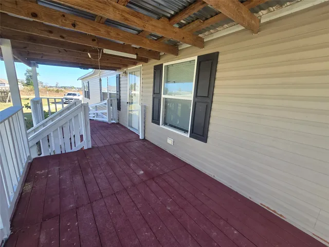 a view of a porch with wooden floor