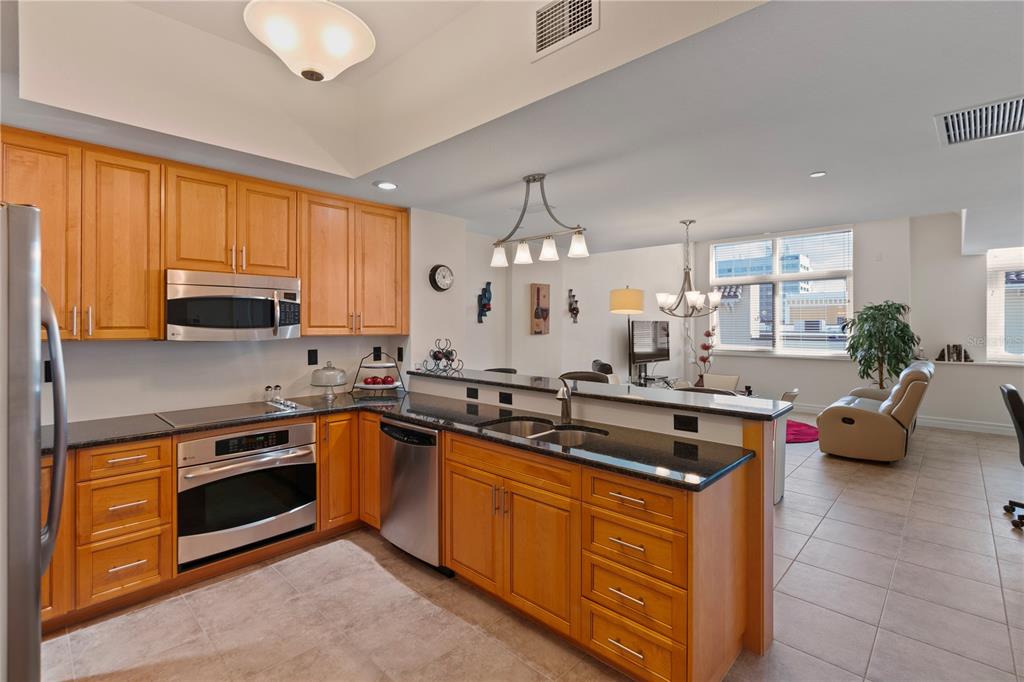 331 Cleveland Street, Unit 312 Clearwater, FL 33755 - Photo 3 of 36 a kitchen with stainless steel appliances a stove sink microwave and cabinets