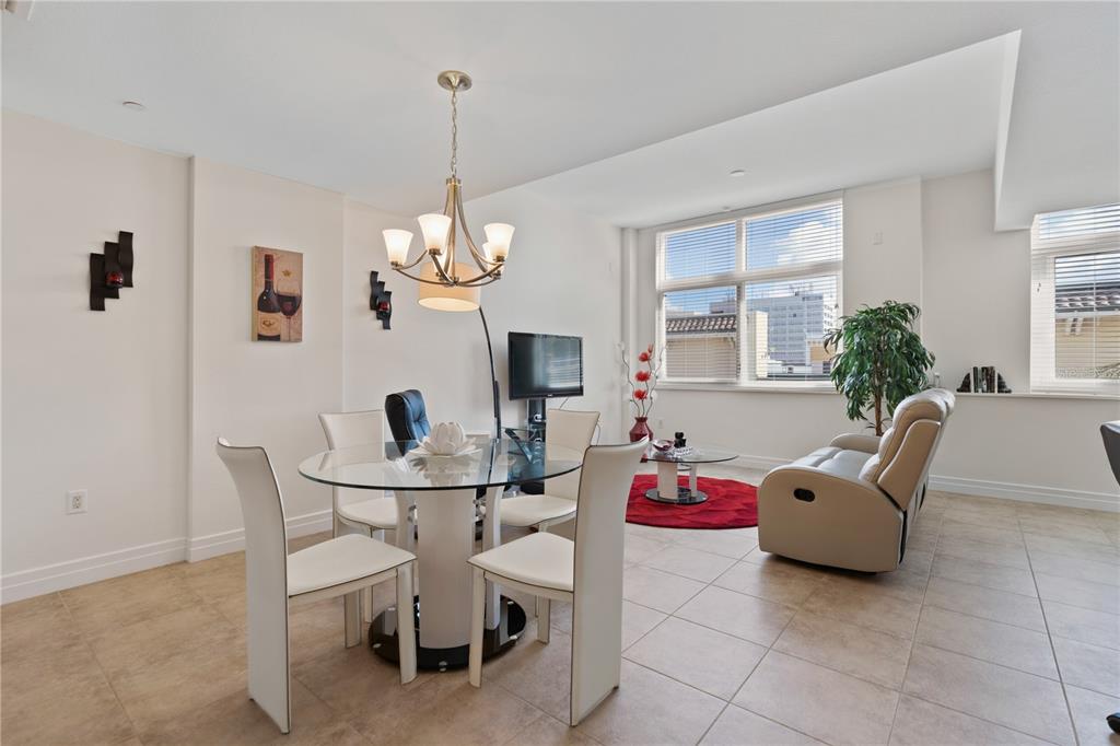 331 Cleveland Street, Unit 312 Clearwater, FL 33755 - Photo 7 of 36 a living room with furniture a window and a chandelier