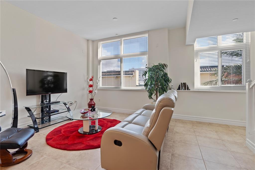 331 Cleveland Street, Unit 312 Clearwater, FL 33755 - Photo 8 of 36 a living room with furniture a flat screen tv and a window